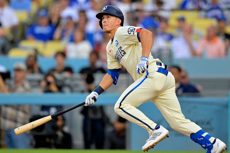 Sep 7, 2024; Los Angeles, California, USA;  Los Angeles Dodgers shortstop Tommy Edman (25) doubles in two runs in the first inning against the Cleveland Guardians at Dodger Stadium. Mandatory Credit: Jayne Kamin-Oncea-Imagn Images