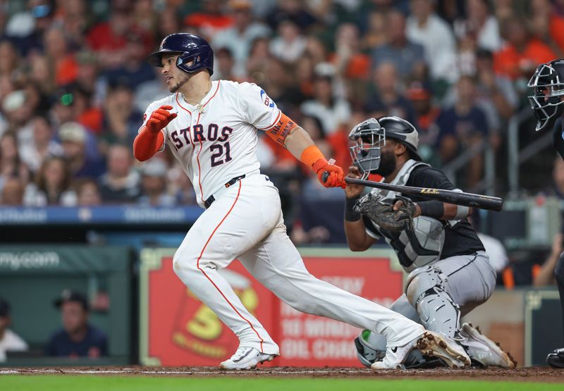 Aug 17, 2024; Houston, Texas, USA; Houston Astros catcher Yainer Diaz (21) hits a single during the third inning against the Chicago White Sox at Minute Maid Park. Mandatory Credit: Troy Taormina-USA TODAY Sports