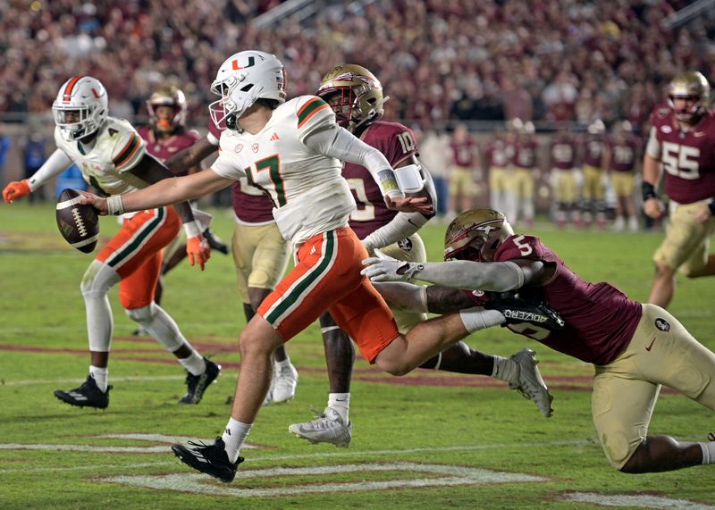 Nov 11, 2023; Tallahassee, Florida, USA; Miami Hurricanes quarterback Emory Williams (17) runs the ball on fourth down against the Florida State Seminoles during the second half at Doak S. Campbell Stadium. Mandatory Credit: Melina Myers-USA TODAY Sports