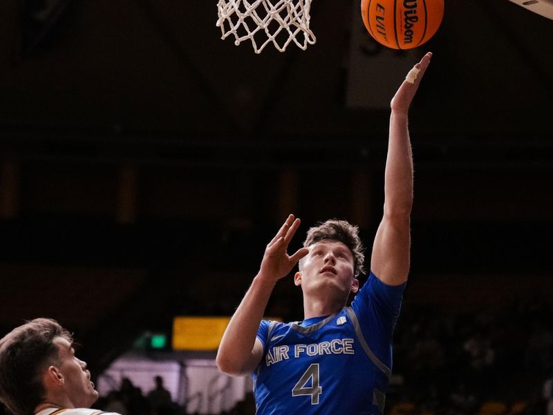 Feb 17, 2023; Laramie, Wyoming, USA; Air Force Falcons guard Carter Murphy (4) scores a basket against Wyoming Cowboys forward Hunter Thompson (10) during the first half at Arena-Auditorium. Mandatory Credit: Troy Babbitt-USA TODAY Sports