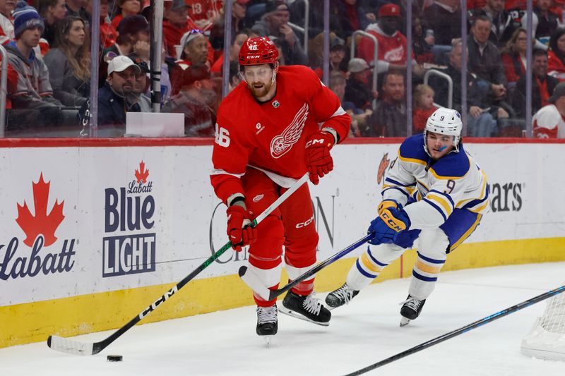 Apr 7, 2024; Detroit, Michigan, USA; Detroit Red Wings defenseman Jeff Petry (46) skates with the puck chased by Buffalo Sabres left wing Zach Benson (9) in the first period at Little Caesars Arena. Mandatory Credit: Rick Osentoski-USA TODAY Sports