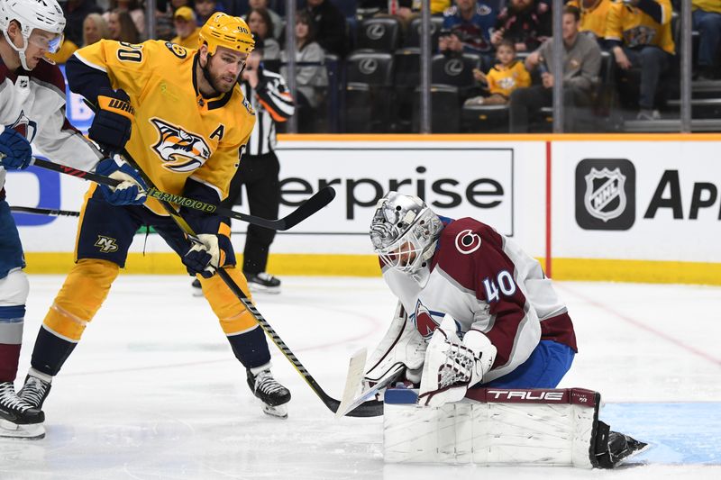 Mar 2, 2024; Nashville, Tennessee, USA; Colorado Avalanche goaltender Alexandar Georgiev (40) makes a save with pressure from Nashville Predators center Ryan O'Reilly (90) during the first period at Bridgestone Arena. Mandatory Credit: Christopher Hanewinckel-USA TODAY Sports