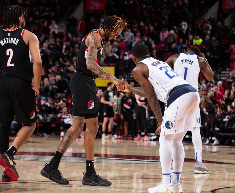 PORTLAND, OR - JANUARY 15: Greg Brown III #4 of the Portland Trail Blazers high fives McKinley Wright IV #23 of the Dallas Mavericks during the game on January 15, 2023 at the Moda Center Arena in Portland, Oregon. NOTE TO USER: User expressly acknowledges and agrees that, by downloading and or using this photograph, user is consenting to the terms and conditions of the Getty Images License Agreement. Mandatory Copyright Notice: Copyright 2023 NBAE (Photo by Cameron Browne/NBAE via Getty Images)