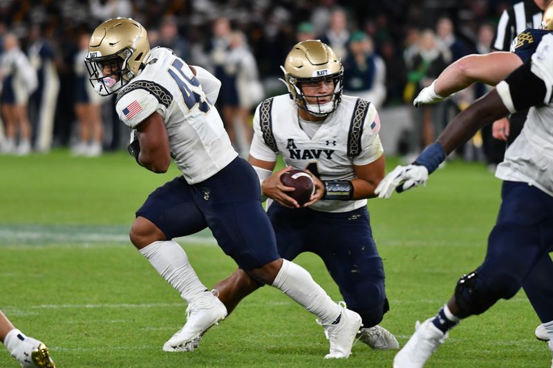 Aug 26, 2023; Dublin, IRL; Navy Midshipmen quarterback Tai Lavatai (1) runs the ball in the first quarter against the Notre Dame Fighting Irish at Aviva Stadium. Mandatory Credit: Matt Cashore-USA TODAY Sports