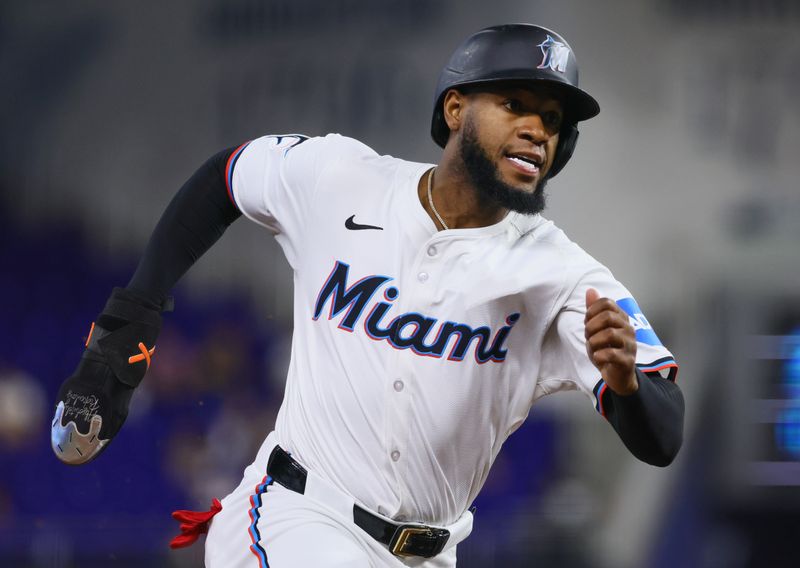 Jun 5, 2024; Miami, Florida, USA; Miami Marlins left fielder Bryan De La Cruz (14) runs toward home plate after an RBI double by right fielder Jesus Sanchez (not pictured) against the Tampa Bay Rays during the first inning at loanDepot Park. Mandatory Credit: Sam Navarro-USA TODAY Sports