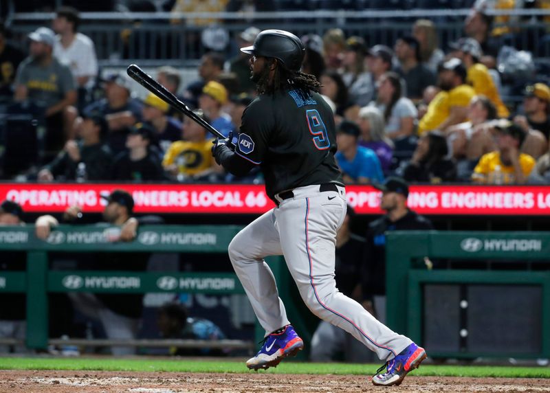 Sep 29, 2023; Pittsburgh, Pennsylvania, USA;  Miami Marlins first baseman Josh Bell (9) hits a two RBI double against the Pittsburgh Pirates during the eighth inning at PNC Park. Mandatory Credit: Charles LeClaire-USA TODAY Sports