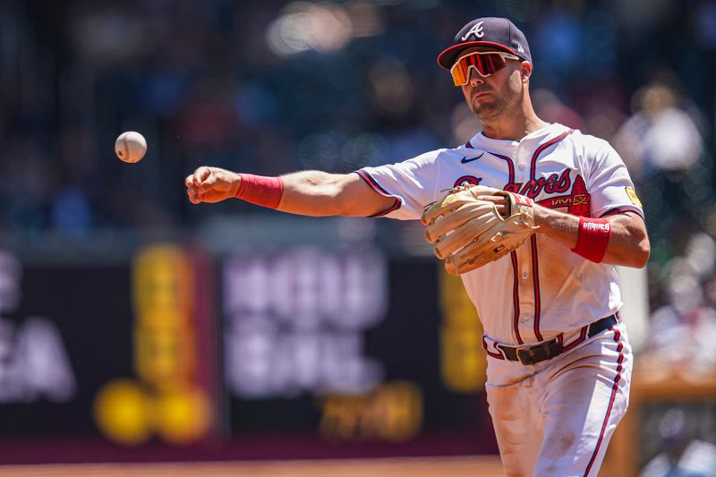 Aug 25, 2024; Cumberland, Georgia, USA; Atlanta Braves second baseman Whit Merrifield (15) throws out Washington Nationals center fielder Jacob Young (30) (not shown) after fielding a ground ball during the second inning at Truist Park. Mandatory Credit: Dale Zanine-USA TODAY Sports