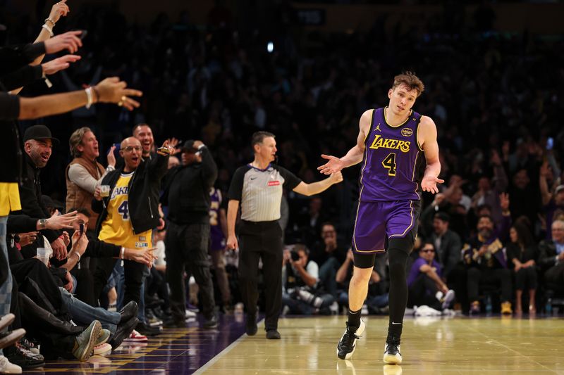 LOS ANGELES, CALIFORNIA - NOVEMBER 19: Dalton Knecht #4 of the Los Angeles Lakers reacts after scoring his fourth consecutive 3-point basket against the Utah Jazz during the third quarter of the Emirates NBA Cup at Crypto.com Arena on November 19, 2024 in Los Angeles, California. NOTE TO USER: User expressly acknowledges and agrees that, by downloading and or using this photograph, User is consenting to the terms and conditions of the Getty Images License Agreement.  (Photo by Harry How/Getty Images)