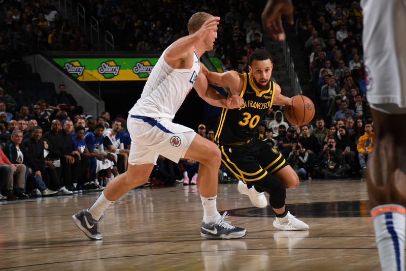 SAN FRANCISCO, CA - FEBRUARY 14: Stephen Curry #30 of the Golden State Warriors dribbles the ball during the game against the LA Clippers on FEBRUARY 14, 2024 at Chase Center in San Francisco, California. NOTE TO USER: User expressly acknowledges and agrees that, by downloading and or using this photograph, user is consenting to the terms and conditions of Getty Images License Agreement. Mandatory Copyright Notice: Copyright 2024 NBAE (Photo by Noah Graham/NBAE via Getty Images)