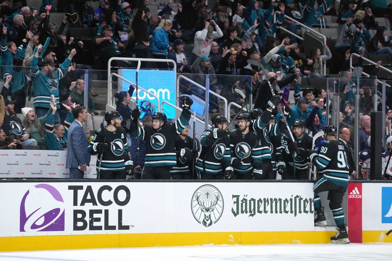 Feb 17, 2024; San Jose, California, USA; San Jose Sharks players react after a goal by left wing Anthony Duclair (not shown) during the first period against the Columbus Blue Jackets at SAP Center at San Jose. Mandatory Credit: Darren Yamashita-USA TODAY Sports