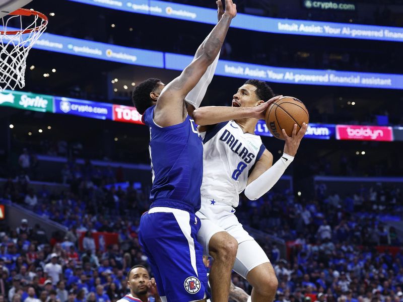 LOS ANGELES, CALIFORNIA - APRIL 21:  Josh Green #8 of the Dallas Mavericks takes a shot against Paul George #13 of the LA Clippers in the second half during game one of the Western Conference First Round Playoffs at Crypto.com Arena on April 21, 2024 in Los Angeles, California.   NOTE TO USER: User expressly acknowledges and agrees that, by downloading and/or using this photograph, user is consenting to the terms and conditions of the Getty Images License Agreement.  (Photo by Ronald Martinez/Getty Images)