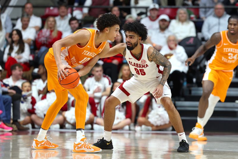Jan 24, 2026; Tuscaloosa, Alabama, USA; Alabama Crimson Tide guard Houston Mallette (95) guards Tennessee Volunteers forward Nate Ament (10) during the second half at Coleman Coliseum. Mandatory Credit: David Leong-Imagn Images