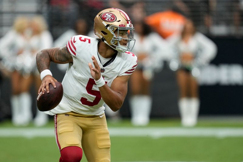 San Francisco 49ers quarterback Trey Lance (5) plays against the Las Vegas Raiders during an NFL football game, Sunday, Aug. 13, 2023, in Las Vegas. (AP Photo/John Locher)