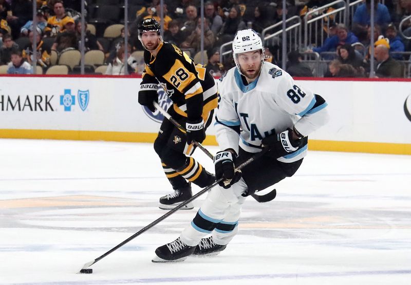 Nov 23, 2024; Pittsburgh, Pennsylvania, USA;  Utah Hockey Club center Kevin Stenlund (82) handles the puck against the Pittsburgh Penguins during the third period at PPG Paints Arena. Mandatory Credit: Charles LeClaire-Imagn Images