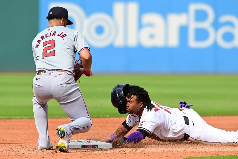 Jun 1, 2024; Cleveland, Ohio, USA; Cleveland Guardians third baseman Jose Ramirez (11) steals second as Washington Nationals second baseman Luis Garcia Jr. (2) waits for the throw during the third inning at Progressive Field. Mandatory Credit: Ken Blaze-USA TODAY Sports