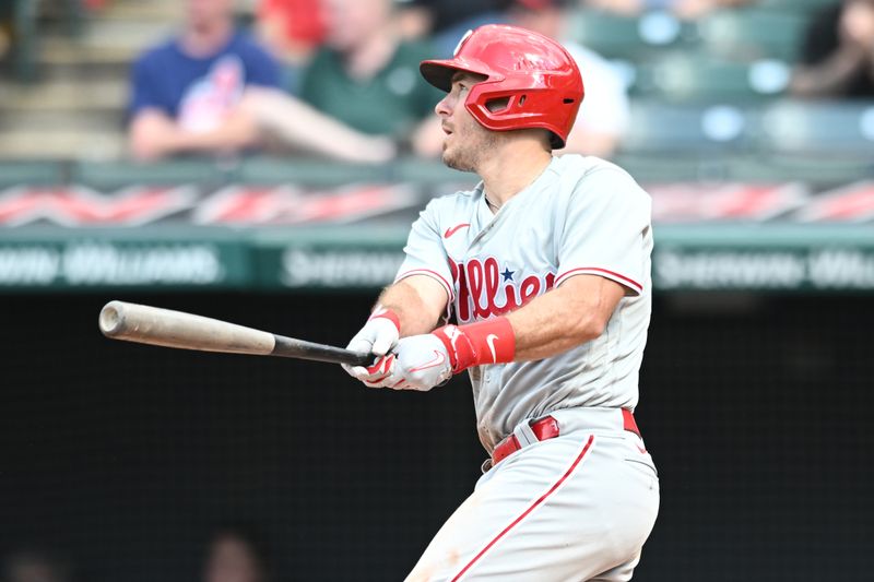 Jul 23, 2023; Cleveland, Ohio, USA; Philadelphia Phillies catcher J.T. Realmuto (10) hits a sacrifice fly during the tenth inning against the Cleveland Guardians at Progressive Field. Mandatory Credit: Ken Blaze-USA TODAY Sports