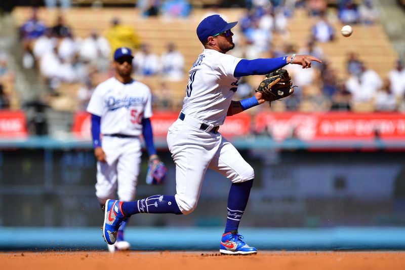 Jun 25, 2023; Los Angeles, California, USA; Los Angeles Dodgers shortstop Miguel Rojas (11) throws to first for the out against Houston Astros second baseman Mauricio Dubon (14) during the first inning at Dodger Stadium. Mandatory Credit: Gary A. Vasquez-USA TODAY Sports