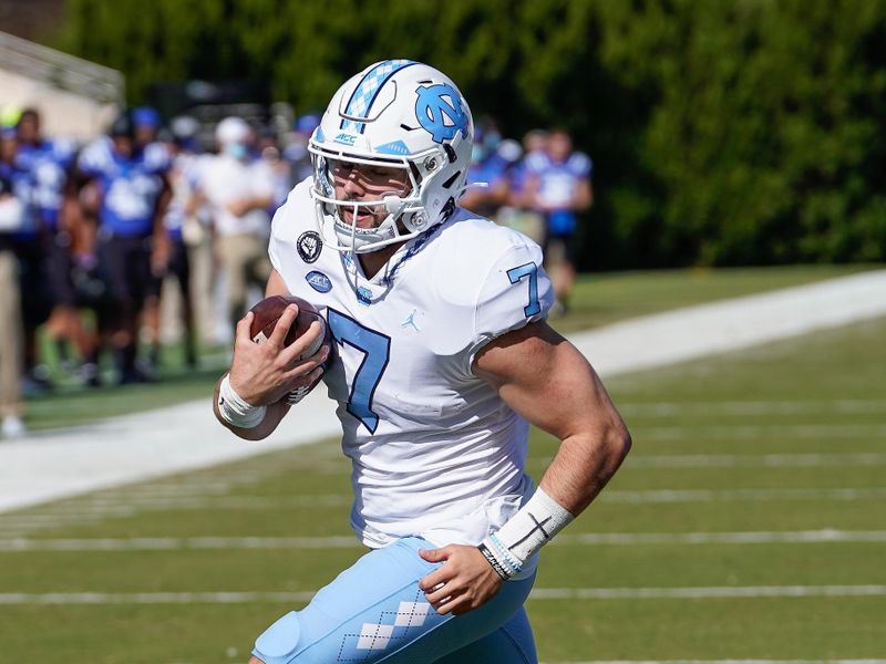 Nov 7, 2020; Durham, North Carolina, USA; North Carolina Tar Heels quarterback Sam Howell (7) scores a touchdown against the Duke Blue Devils during the first quarter at Wallace Wade Stadium. Mandatory Credit: Jim Dedmon-USA TODAY Sports