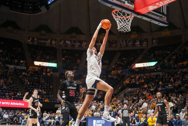 Jan 31, 2024; Morgantown, West Virginia, USA; West Virginia Mountaineers center Jesse Edwards (7) dunks the ball during the second half against the Cincinnati Bearcats at WVU Coliseum. Mandatory Credit: Ben Queen-USA TODAY Sports