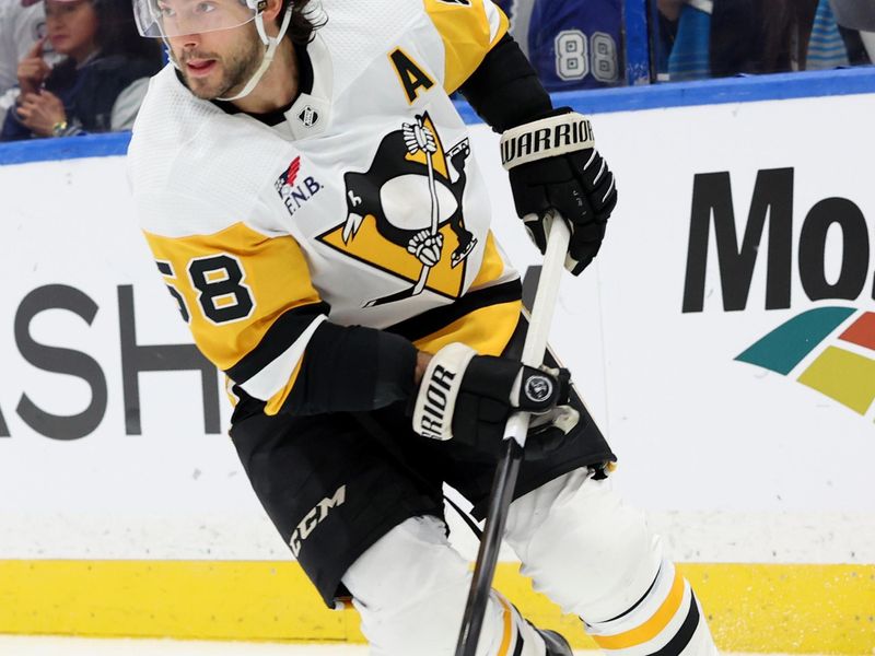 Dec 6, 2023; Tampa, Florida, USA; Pittsburgh Penguins defenseman Kris Letang (58) skates with the puck against the Tampa Bay Lightning during the first period at Amalie Arena. Mandatory Credit: Kim Klement Neitzel-USA TODAY Sports