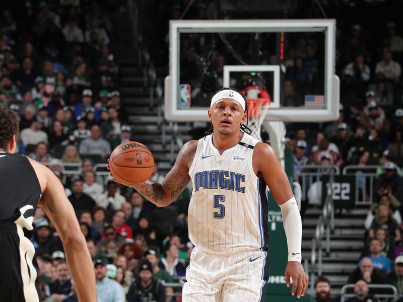 MILWAUKEE, WI - JANUARY 15:  Paolo Banchero #5 of the Orlando Magic handles the ball during the game against the Milwaukee Bucks on January 15, 2025 at Fiserv Forum Center in Milwaukee, Wisconsin. NOTE TO USER: User expressly acknowledges and agrees that, by downloading and or using this Photograph, user is consenting to the terms and conditions of the Getty Images License Agreement. Mandatory Copyright Notice: Copyright 2025 NBAE (Photo by Gary Dineen/NBAE via Getty Images).