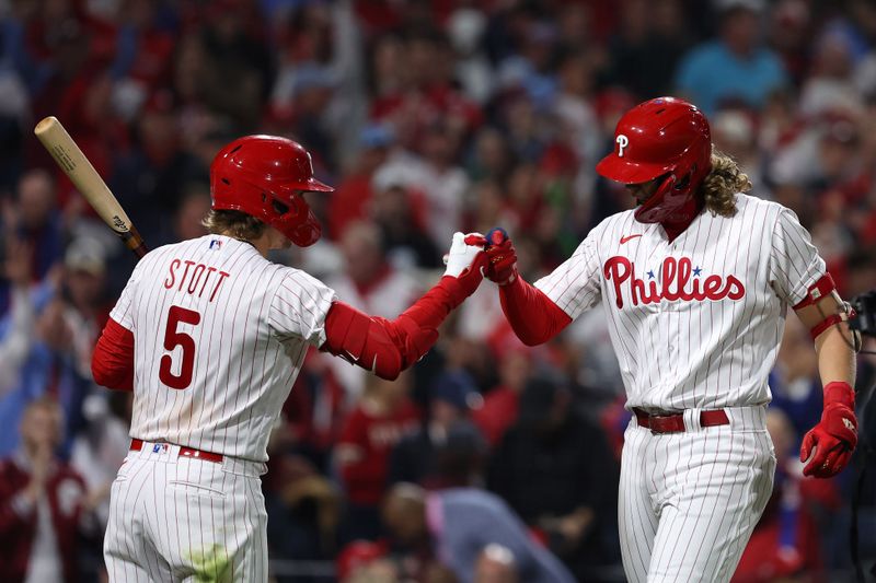 Oct 24, 2023; Philadelphia, Pennsylvania, USA; Philadelphia Phillies first baseman Alec Bohm (28) reacts with second baseman Bryson Stott (5) after hitting a home run against the Arizona Diamondbacks in the second inning for game seven of the NLCS for the 2023 MLB playoffs at Citizens Bank Park. Mandatory Credit: Bill Streicher-USA TODAY Sports