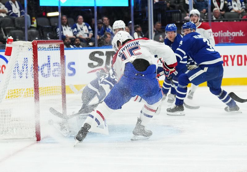 Oct 11, 2023; Toronto, Ontario, CAN; Montreal Canadiens center Alex Newhook (15) scores a goal against the Toronto Maple Leafs during the second period at Scotiabank Arena. Mandatory Credit: Nick Turchiaro-USA TODAY Sports