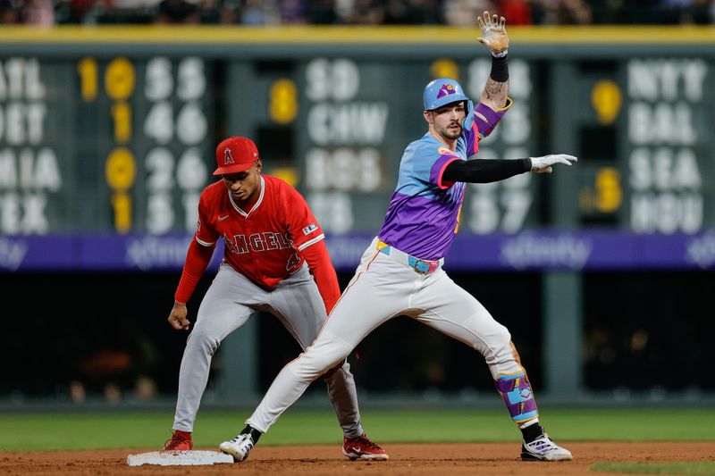 Sep 19, 2025; Denver, Colorado, USA; Colorado Rockies center fielder Brenton Doyle (9) slides safely into second against Los Angeles Angels second baseman Christian Moore (4) on two RBI double in the fifth inning at Coors Field. Mandatory Credit: Isaiah J. Downing-Imagn Images