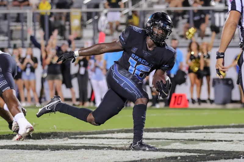 Oct 13, 2022; Orlando, Florida, USA; UCF Knights quarterback Brock Hansel (16) scores a touchdown during the second half against the Temple Owls at FBC Mortgage Stadium. Mandatory Credit: Mike Watters-USA TODAY Sports