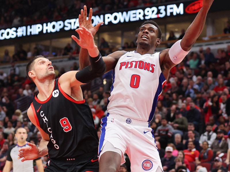 CHICAGO, ILLINOIS - FEBRUARY 27: Nikola Vucevic #9 of the Chicago Bulls and Jalen Duren #0 of the Detroit Pistons battle for a rebound during the second half at the United Center on February 27, 2024 in Chicago, Illinois. NOTE TO USER: User expressly acknowledges and agrees that, by downloading and or using this photograph, User is consenting to the terms and conditions of the Getty Images License Agreement. (Photo by Michael Reaves/Getty Images)