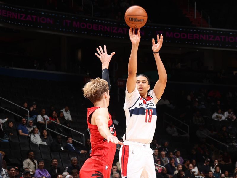 WASHINGTON, DC -? OCTOBER 11: Kyshawn George #18 of the Washington Wizards shoots a three point basket during the game against the Toronto Raptors during a NBA preseason game on October 11, 2024 at Capital One Arena in Washington, DC. NOTE TO USER: User expressly acknowledges and agrees that, by downloading and or using this Photograph, user is consenting to the terms and conditions of the Getty Images License Agreement. Mandatory Copyright Notice: Copyright 2024 NBAE (Photo by Stephen Gosling/NBAE via Getty Images)