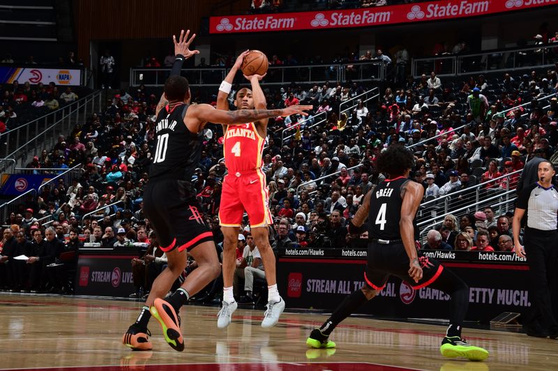 ATLANTA, GA - FEBRUARY 10: Kobe Bufkin #4 of the Atlanta Hawks shoots a three point basket against the Houston Rockets on February 10, 2024 at State Farm Arena in Atlanta, Georgia.  NOTE TO USER: User expressly acknowledges and agrees that, by downloading and/or using this Photograph, user is consenting to the terms and conditions of the Getty Images License Agreement. Mandatory Copyright Notice: Copyright 2024 NBAE (Photo by Scott Cunningham/NBAE via Getty Images)