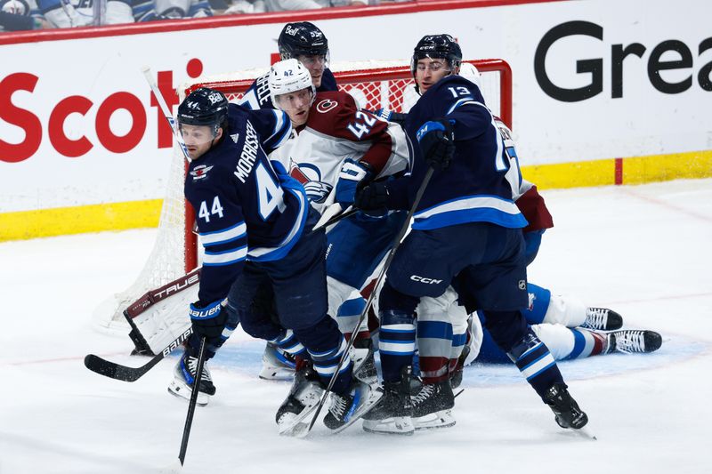 Apr 23, 2024; Winnipeg, Manitoba, CAN; Colorado Avalanche defenseman Josh Manson (42) jostles for position with Winnipeg Jets forward Mark Scheifele (55),  defenseman Josh Morrissey (44), and forward Gabriel Vilardi (13) during the third period in game two of the first round of the 2024 Stanley Cup Playoffs at Canada Life Centre. Mandatory Credit: Terrence Lee-USA TODAY Sports