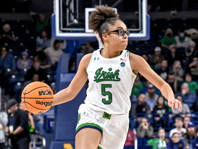 Feb 16, 2023; South Bend, Indiana, USA; Notre Dame Fighting Irish guard Olivia Miles (5) passes the ball in the second half against the Louisville Cardinals at the Purcell Pavilion. Mandatory Credit: Matt Cashore-USA TODAY Sports