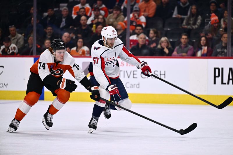 Dec 14, 2023; Philadelphia, Pennsylvania, USA; Philadelphia Flyers right wing Owen Tippett (74) reaches for the puck against Washington Capitals defenseman Trevor van Riemsdyk (57) in the first period at Wells Fargo Center. Mandatory Credit: Kyle Ross-USA TODAY Sports