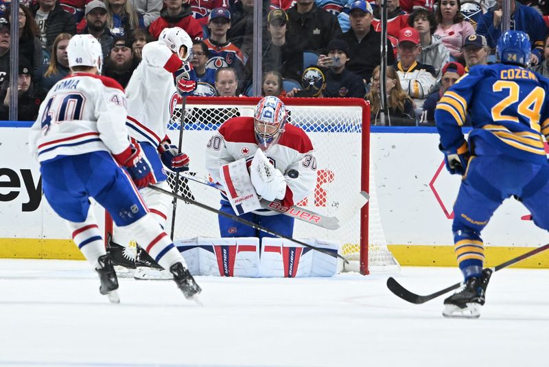 Nov 11, 2024; Buffalo, New York, USA; Montreal Canadiens goaltender Cayden Primeau (30) stops a shot on goal by the Buffalo Sabres in the first period at KeyBank Center. Mandatory Credit: Mark Konezny-Imagn Images