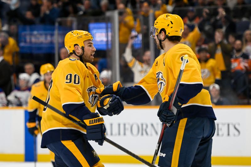 Oct 17, 2024; Nashville, Tennessee, USA;  Nashville Predators center Ryan O'Reilly (90) celebrates the goal of left wing Filip Forsberg (9) against the Edmonton Oilers during the first period at Bridgestone Arena. Mandatory Credit: Steve Roberts-Imagn Images