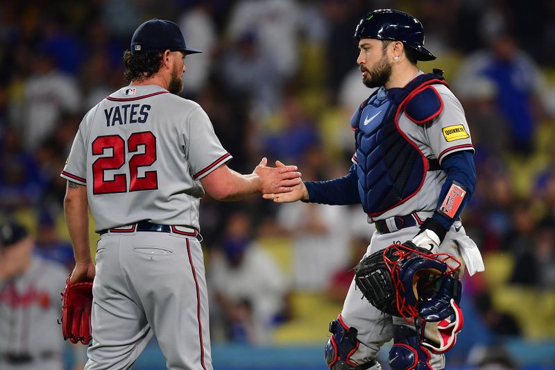 September 1, 2023; Los Angeles, California, USA; Atlanta Braves relief pitcher Kirby Yates (22) and catcher Travis d'Arnaud (16) celebrate the victory against the Los Angeles Dodgers at Dodger Stadium. Mandatory Credit: Gary A. Vasquez-USA TODAY Sports