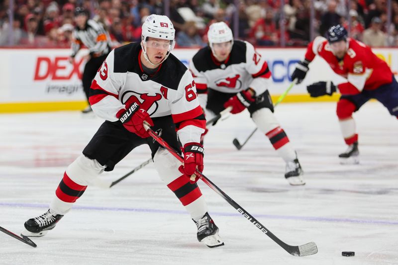 Jan 13, 2024; Sunrise, Florida, USA; New Jersey Devils left wing Jesper Bratt (63) moves the puck against the Florida Panthers during the first period at Amerant Bank Arena. Mandatory Credit: Sam Navarro-USA TODAY Sports