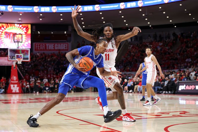 Dec 29, 2025; Houston, Texas, USA; Middle Tennessee Blue Raiders forward Torey Alston (10) drives with the ball as Houston Cougars forward Joseph Tugler (11) defends during the first half at Fertitta Center. Mandatory Credit: Troy Taormina-Imagn Images