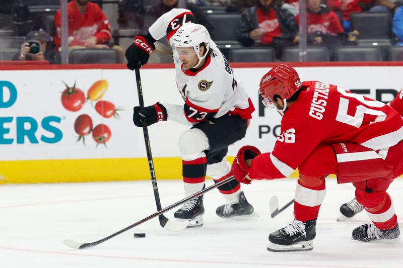 Oct 4, 2024; Detroit, Michigan, USA;  Ottawa Senators left wing Noah Gregor (73) skates with the puck while chased by Detroit Red Wings defenseman Erik Gustafsson (56) in the first period at Little Caesars Arena. Mandatory Credit: Rick Osentoski-Imagn Images