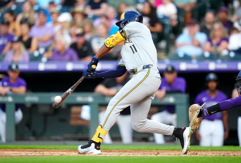 Jul 1, 2024; Denver, Colorado, USA; Milwaukee Brewers outfielder Jackson Chourio (11) hits a two run single during the fourth inning against the Colorado Rockies at Coors Field. Mandatory Credit: Ron Chenoy-USA TODAY Sports