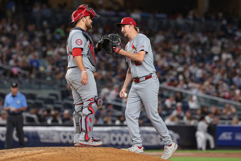 Aug 30, 2024; Bronx, New York, USA;  St. Louis Cardinals starting pitcher Erick Fedde (12) slaps gloves with catcher Pedro Pages (43) before being received during the sixth inning against the New York Yankees at Yankee Stadium. Mandatory Credit: Vincent Carchietta-USA TODAY Sports