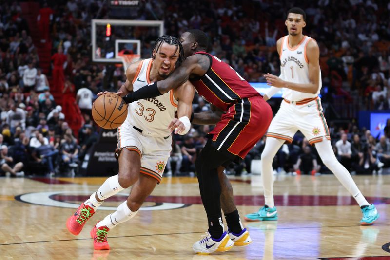 MIAMI, FLORIDA - FEBRUARY 07: Tre Jones #33 of the San Antonio Spurs drives against Terry Rozier #2 of the Miami Heat during the fourth quarter of the game at Kaseya Center on February 07, 2024 in Miami, Florida. NOTE TO USER: User expressly acknowledges and agrees that, by downloading and or using this photograph, User is consenting to the terms and conditions of the Getty Images License Agreement. (Photo by Megan Briggs/Getty Images)