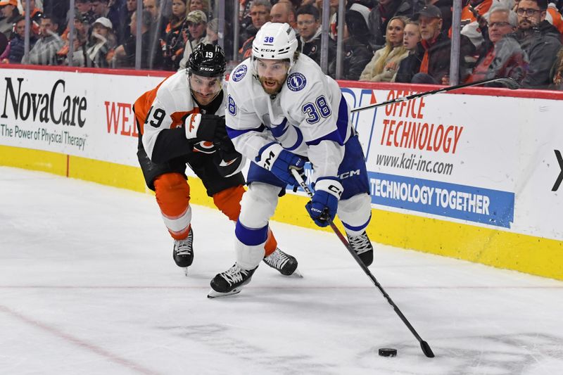 Feb 27, 2024; Philadelphia, Pennsylvania, USA; Tampa Bay Lightning left wing Brandon Hagel (38) carries the puck against Philadelphia Flyers right wing Garnet Hathaway (19) during the second period at Wells Fargo Center. Mandatory Credit: Eric Hartline-USA TODAY Sports