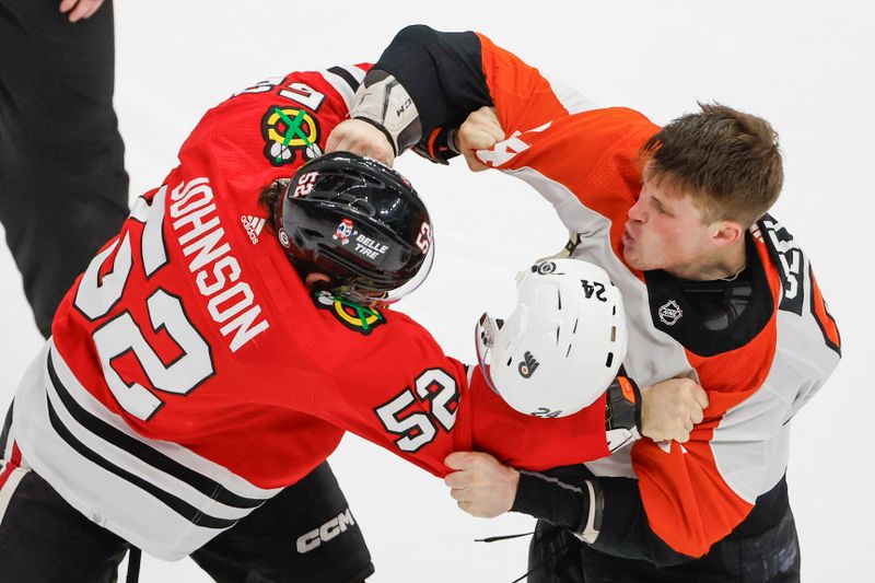 Feb 21, 2024; Chicago, Illinois, USA; Philadelphia Flyers defenseman Nick Seeler (24) fights with Chicago Blackhawks center Reese Johnson (52) during the third period at United Center. Mandatory Credit: Kamil Krzaczynski-USA TODAY Sports