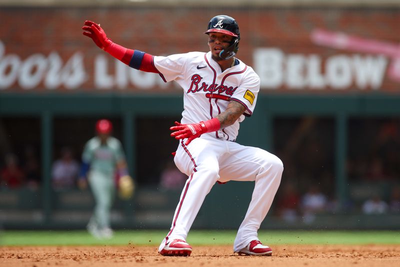 Jul 7, 2024; Atlanta, Georgia, USA; Atlanta Braves shortstop Orlando Arcia (11) runs the bases against the Philadelphia Phillies in the second inning at Truist Park. Mandatory Credit: Brett Davis-USA TODAY Sports
