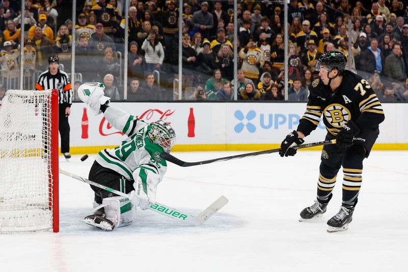 Feb 19, 2024; Boston, Massachusetts, USA; Boston Bruins defenseman Charlie McAvoy (73) scores the winning goal in a shootout past Dallas Stars goaltender Jake Ottinger (29) at TD Garden. Mandatory Credit: Winslow Townson-USA TODAY Sports