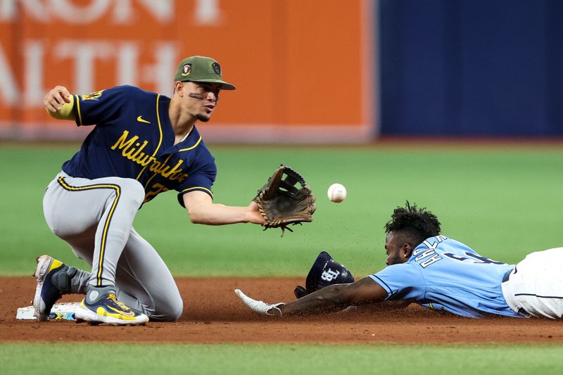 May 21, 2023; St. Petersburg, Florida, USA;  Tampa Bay Rays left fielder Randy Arozarena (56) steals second base from Milwaukee Brewers shortstop Willy Adames (27) in the eighth inning at Tropicana Field. Mandatory Credit: Nathan Ray Seebeck-USA TODAY Sports