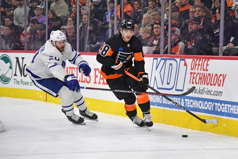 Mar 19, 2024; Philadelphia, Pennsylvania, USA; Philadelphia Flyers center Morgan Frost (48) carries the puck against Toronto Maple Leafs defenseman Joel Edmundson (20) during the third period at Wells Fargo Center. Mandatory Credit: Eric Hartline-USA TODAY Sports